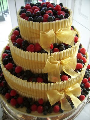 Three tier chocolate curls cake with beige bows and stacked with 